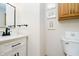 Clean half bath featuring a white vanity with black hardware and decorative wall art at 3892 Arrowhead Ct, Greenfield, IN 46140