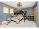 This bedroom has carpet floors, a ceiling fan, bunk beds, LED accent lights, and a window at 3892 Arrowhead Ct, Greenfield, IN 46140