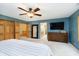 This is a bedroom with carpet floors, a ceiling fan, closet, mirror, and a view of the ensuite bathroom at 3892 Arrowhead Ct, Greenfield, IN 46140