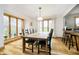Bright dining room with hardwood floors, large windows, and modern lighting fixtures at 3892 Arrowhead Ct, Greenfield, IN 46140