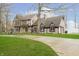 Stately home with stone and Tudor accents, surrounded by lush greenery and mature trees at 3892 Arrowhead Ct, Greenfield, IN 46140