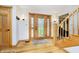 Inviting foyer with hardwood floors, a grand staircase, and a stylish front door at 3892 Arrowhead Ct, Greenfield, IN 46140