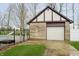 Side view of a brick garage with a white door and a matching design to the main house at 3892 Arrowhead Ct, Greenfield, IN 46140