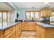Bright kitchen with wood cabinetry, granite counters, and an open layout at 3892 Arrowhead Ct, Greenfield, IN 46140