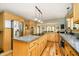Spacious kitchen with stainless steel appliances, an island, hardwood floors, and light wood cabinets at 3892 Arrowhead Ct, Greenfield, IN 46140