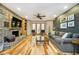 Bright living room featuring a brick fireplace, hardwood floors, and a ceiling fan at 3892 Arrowhead Ct, Greenfield, IN 46140