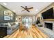 Living room with hardwood floors, fireplace, and sliding glass door access at 3892 Arrowhead Ct, Greenfield, IN 46140