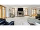 Cozy living room with a brick fireplace, large windows, and plush seating arrangements at 3892 Arrowhead Ct, Greenfield, IN 46140