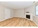 Spacious finished basement featuring an electric fireplace, vinyl plank flooring, and natural light at 4064 Waterfield Dr, Indianapolis, IN 46235