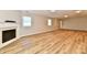 Spacious finished basement featuring an electric fireplace, vinyl plank flooring, and natural light at 4064 Waterfield Dr, Indianapolis, IN 46235
