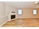 Spacious finished basement featuring an electric fireplace, vinyl plank flooring, and natural light at 4064 Waterfield Dr, Indianapolis, IN 46235