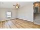 Bright bedroom featuring a ceiling fan, vinyl plank flooring, neutral paint, and natural light at 4064 Waterfield Dr, Indianapolis, IN 46235