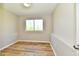 Light filled room with wood-look floors, a window, and neutral colored walls at 4064 Waterfield Dr, Indianapolis, IN 46235