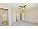 Bedroom featuring carpet, ceiling fan, ensuite bathroom, and closet at 4064 Waterfield Dr, Indianapolis, IN 46235