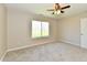 Well-lit carpeted bedroom with fan and a scenic view from the window at 4064 Waterfield Dr, Indianapolis, IN 46235