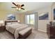 Bright bedroom featuring a ceiling fan, a large window, and a nicely decorated bed with neutral accents at 4064 Waterfield Dr, Indianapolis, IN 46235