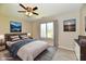 A staged bedroom featuring a bed, a window with curtains, and paintings on the wall at 4064 Waterfield Dr, Indianapolis, IN 46235