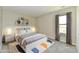 Comfortable bedroom featuring modern decor, a large window, and stylish furnishings on a plush carpet at 4064 Waterfield Dr, Indianapolis, IN 46235