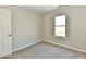 Bedroom showcasing a light-filled window and plush neutral carpet at 4064 Waterfield Dr, Indianapolis, IN 46235