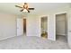 Bedroom featuring carpet, ceiling fan, ensuite bathroom, and closet at 4064 Waterfield Dr, Indianapolis, IN 46235
