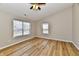 Bedroom featuring wood floors, a ceiling fan, and two windows with natural light at 4064 Waterfield Dr, Indianapolis, IN 46235