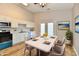 Bright dining area featuring marble table, plush chairs, and adjacent kitchen with modern appliances at 4064 Waterfield Dr, Indianapolis, IN 46235