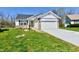 Charming single-story home featuring a two-car garage and a well-maintained lawn at 4064 Waterfield Dr, Indianapolis, IN 46235