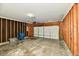 Unfinished garage with exposed studs and a garage door at 4064 Waterfield Dr, Indianapolis, IN 46235