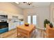 Bright kitchen featuring white cabinets, stainless steel appliances, and a central island on hardwood floors at 4064 Waterfield Dr, Indianapolis, IN 46235