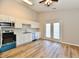 Bright eat-in kitchen featuring stainless steel appliances, white cabinetry, and vinyl plank flooring at 4064 Waterfield Dr, Indianapolis, IN 46235