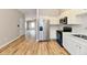 Bright eat-in kitchen featuring stainless steel appliances, white cabinetry, and vinyl plank flooring at 4064 Waterfield Dr, Indianapolis, IN 46235