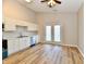 Bright eat-in kitchen featuring stainless steel appliances, white cabinetry, and vinyl plank flooring at 4064 Waterfield Dr, Indianapolis, IN 46235