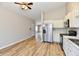 Bright eat-in kitchen featuring stainless steel appliances, white cabinetry, and vinyl plank flooring at 4064 Waterfield Dr, Indianapolis, IN 46235