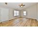 Bright living room with wood floors, ceiling fan, and natural light from two windows at 4064 Waterfield Dr, Indianapolis, IN 46235