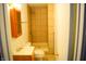 Standard bathroom with a tiled shower, vanity, and toilet; compact and functional space at 4107 Eisenhower Dr, Indianapolis, IN 46254