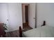 Comfortable bedroom featuring hardwood flooring and access to an adjacent room at 4107 Eisenhower Dr, Indianapolis, IN 46254