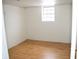 A spacious bedroom with laminate flooring, a window, and painted cinder block walls at 4107 Eisenhower Dr, Indianapolis, IN 46254