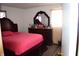 Spacious bedroom featuring a full size bed and a wooden dresser with ornate mirror at 4107 Eisenhower Dr, Indianapolis, IN 46254
