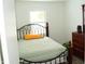 Charming bedroom with a metal frame bed and a dark wood dresser at 4107 Eisenhower Dr, Indianapolis, IN 46254