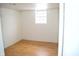 Bedroom featuring laminate floors, painted cinder block walls, and a window at 4107 Eisenhower Dr, Indianapolis, IN 46254