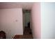 Long hallway with hardwood floors, white walls, and doorways leading to rooms at 4107 Eisenhower Dr, Indianapolis, IN 46254