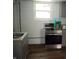 Basement kitchen with stainless steel appliances, gray cabinets, and a window at 4107 Eisenhower Dr, Indianapolis, IN 46254