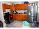 Functional kitchen features wooden cabinets, a modern refrigerator, and updated appliances at 4107 Eisenhower Dr, Indianapolis, IN 46254