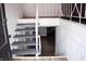 Stairway leading to the basement with painted stairs and metal railings at 4107 Eisenhower Dr, Indianapolis, IN 46254