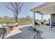 Covered patio with seating and a beautiful stone paver patio with a fire pit feature at 4140 Omaha Dr, Bargersville, IN 46106