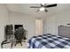 Bedroom features a ceiling fan, neutral walls, carpeted floors, and a checkered bed spread and desk setup at 4140 Omaha Dr, Bargersville, IN 46106