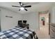 Bedroom features a ceiling fan, neutral walls, carpeted floors, and a checkered bed spread and desk setup at 4140 Omaha Dr, Bargersville, IN 46106