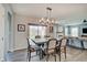A beautifully staged dining room shows seating for six under a modern chandelier, open to the living room and backyard at 4140 Omaha Dr, Bargersville, IN 46106