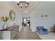 Inviting entryway featuring wood floors, a decorative mirror, modern lighting, and an open view to the living room at 4140 Omaha Dr, Bargersville, IN 46106