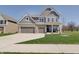 Charming two-story home with a three car garage, gray siding, brick accents and a well-manicured lawn at 4140 Omaha Dr, Bargersville, IN 46106